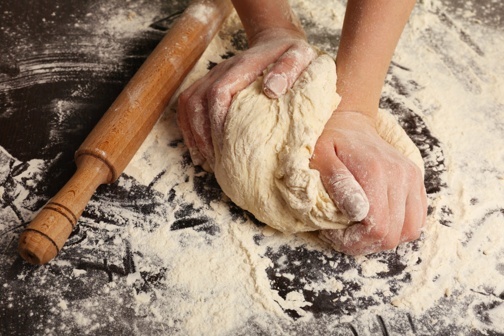 Making Dough By Female Hands On Wooden Table